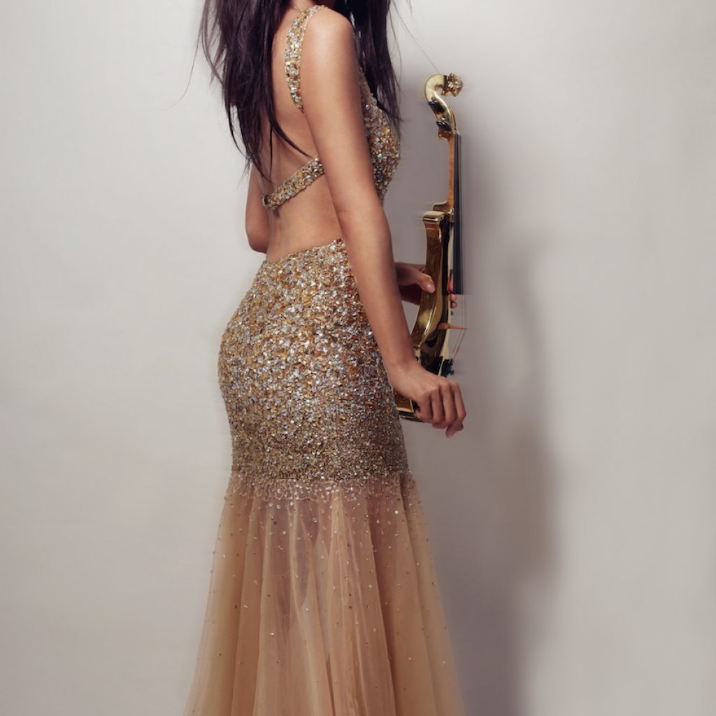 Linzi Stoppard electric violinist styling a gold dress with 24carat golden violin